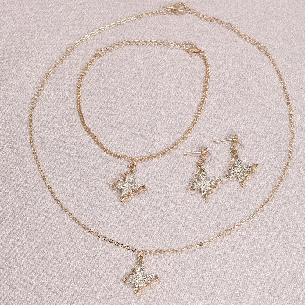 Ensemble bijoux trois pièces : boucles d'oreilles papillon, collier avec pendentif, bracelet,